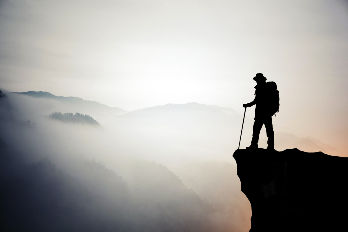 Silhouette of hiking man in mountain